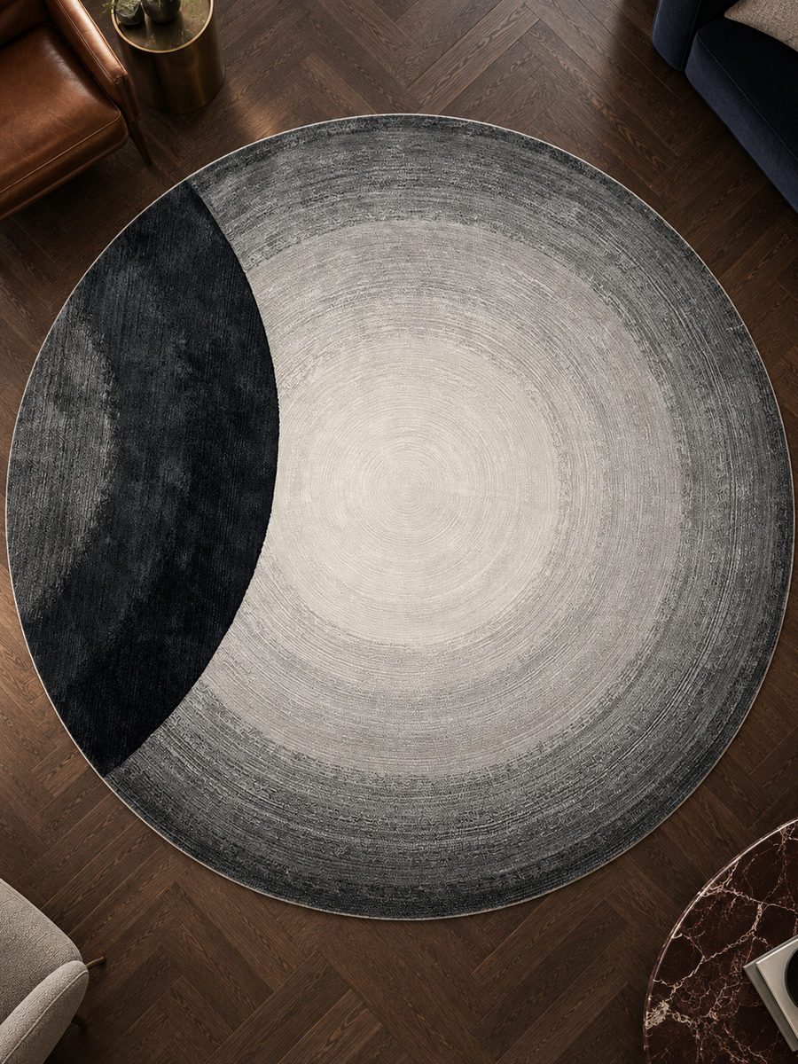 Rond vloerkleed Eclips met grijze cirkels en een zwarte sikkel, collectie kleurvlakken